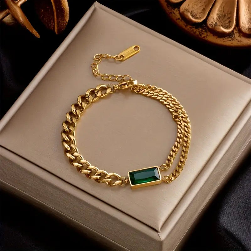 Goldenes Kettenarmband mit Smaragd-Barrelement
