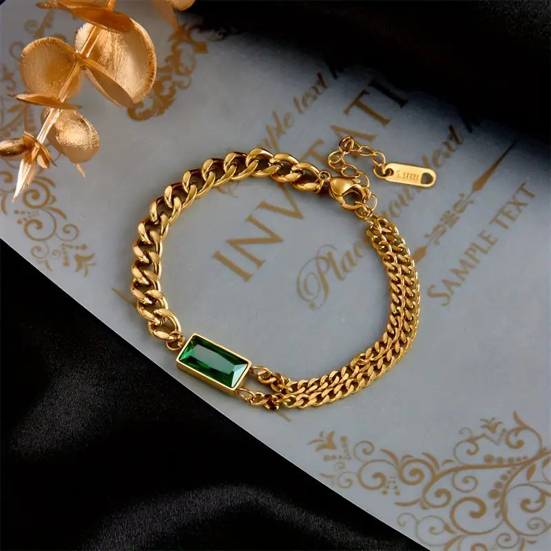 Goldenes Kettenarmband mit Smaragd-Barrelement