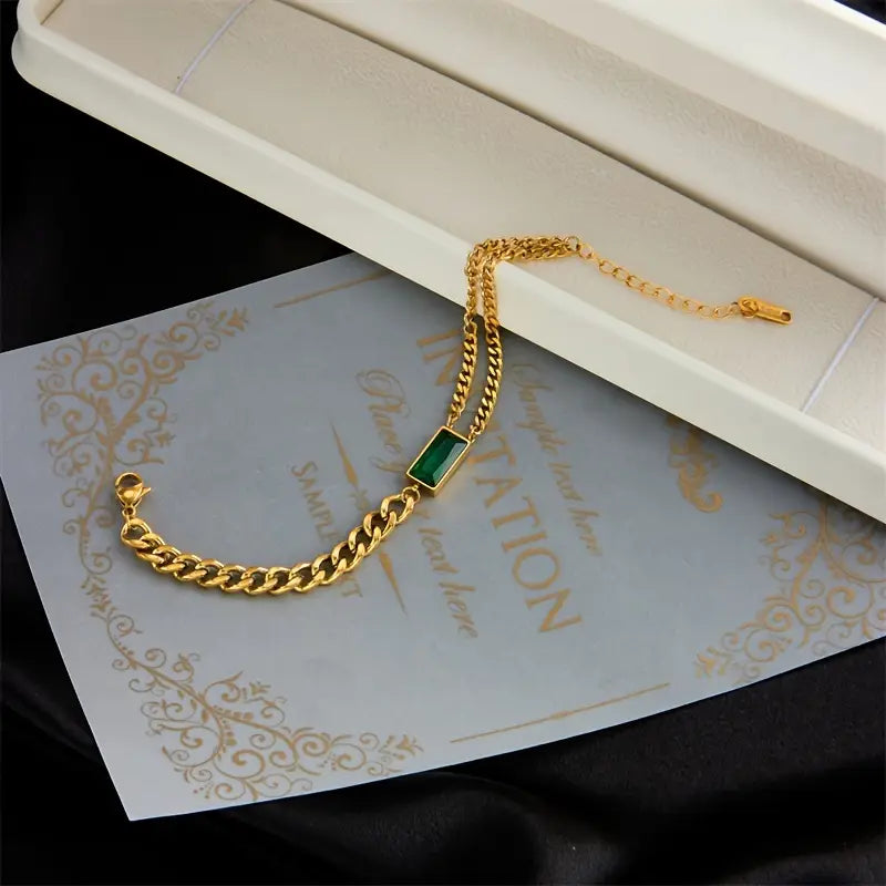 Goldenes Kettenarmband mit Smaragd-Barrelement